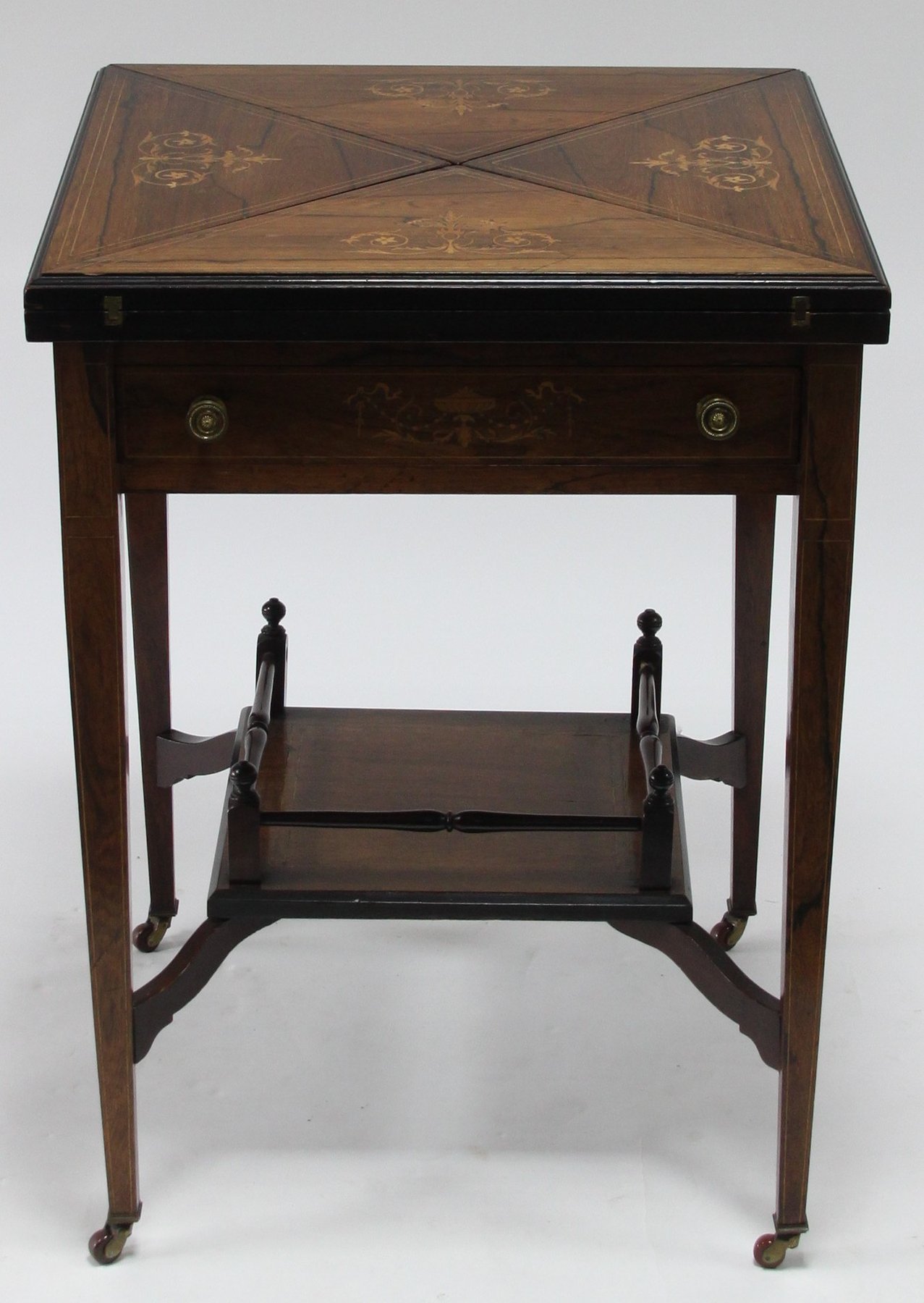 Appraisal: An Edwardian envelope card table the quarter segmented top inlaid