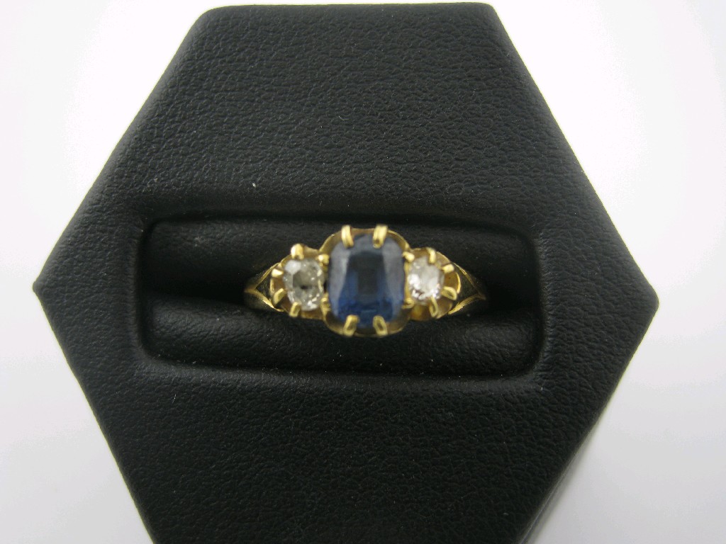 Appraisal: A Sapphire and Diamond three stone Ring claw-set central sapphire