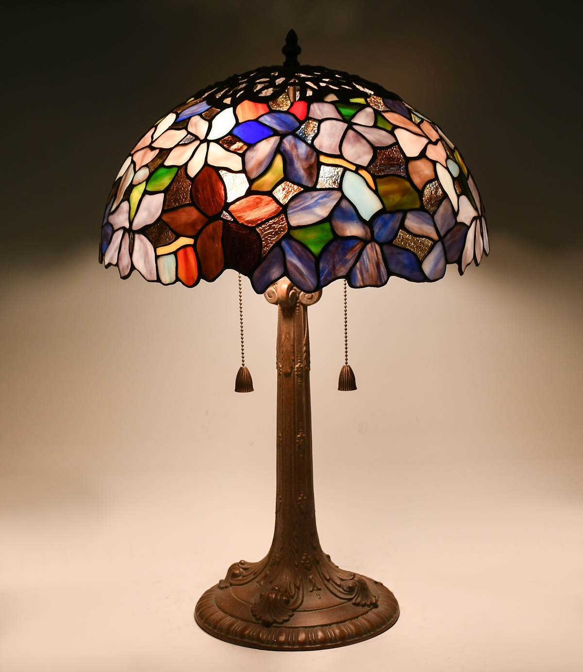 Appraisal: STAINED GLASS FLORAL LAMP Colorful leaded glass shade having a