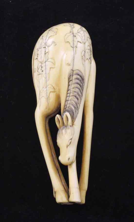 Appraisal: A large Japanese ivory netsuke of a grazing horse later