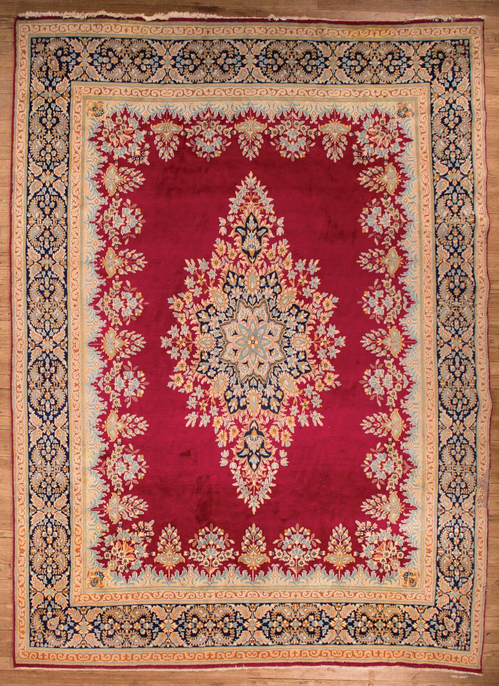 Appraisal: Kirman Carpet red ground central medallion floral border ft in