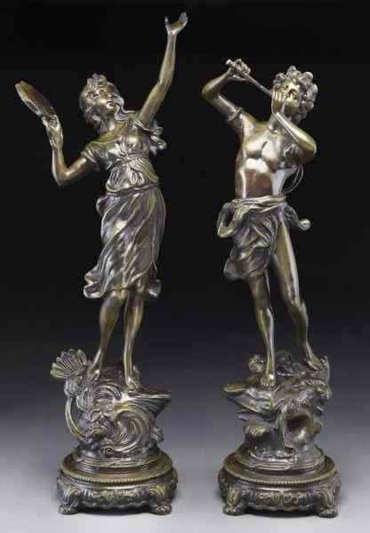 Appraisal: Pr Patinated bronze sculpturesmodeled as classical figures playing instruments having