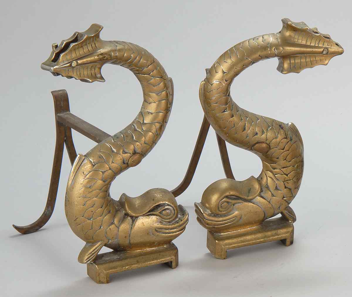 Appraisal: PAIR OF BRASS DOLPHIN-FORM ANDIRONS With iron supports Heights differ