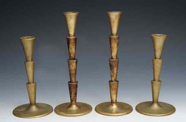 Appraisal: A set of four Cubist brass candlesticks in the manner