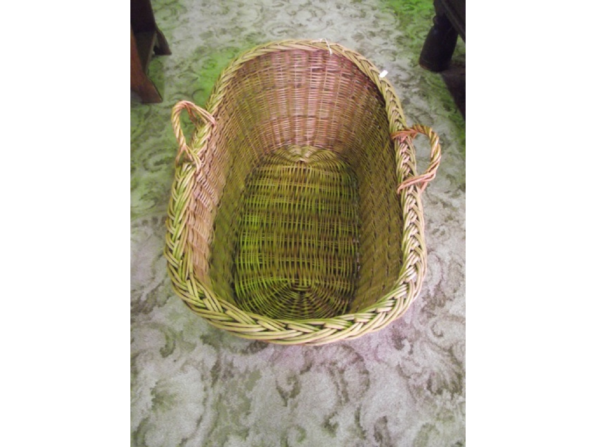 Appraisal: A vintage wicker baby basket with loop handles