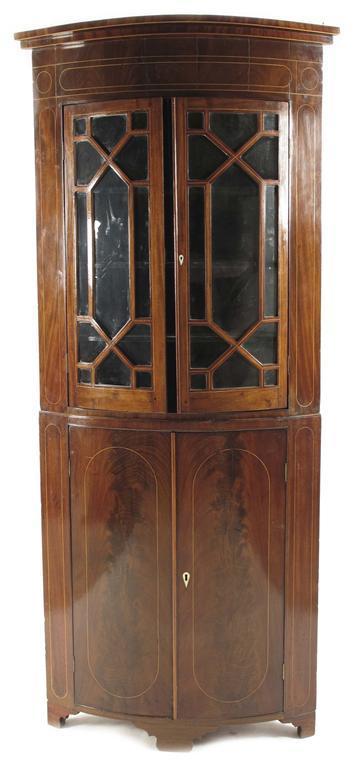 Appraisal: A th century mahogany bowfront standing corner cupboard