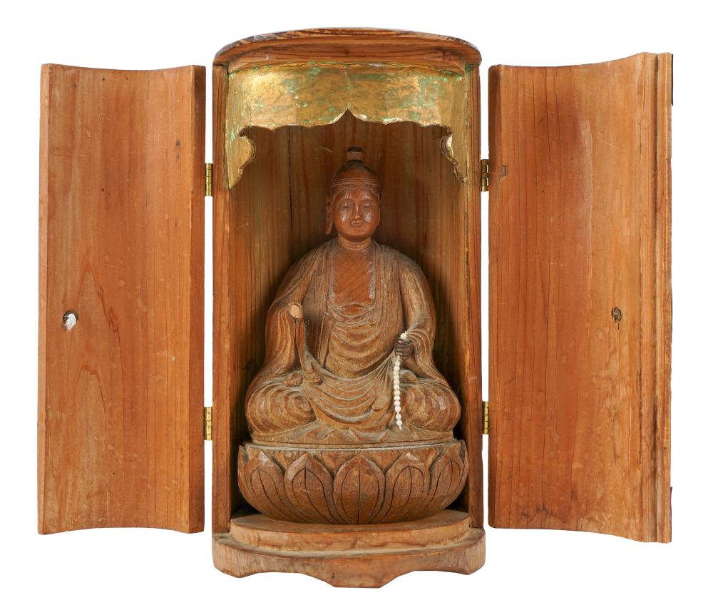 Appraisal: CARVED WOOD BUDDHA FIGUREsigned to underside in a wooden shrine