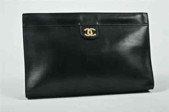 Appraisal: CHANEL NAVY LEATHER CLUTCH With burgundy leather interior with gold-tone