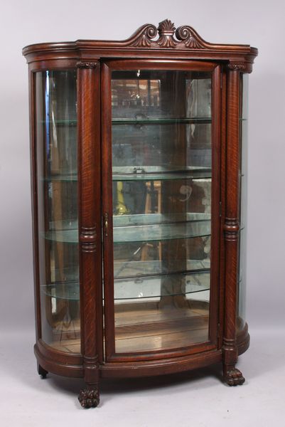 Appraisal: Late th Century carved tiger oak curved glass china cabinet