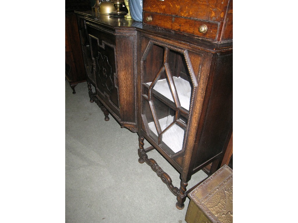 Appraisal: Jacobean style oak breakfront sideboard with astragal glazed door side