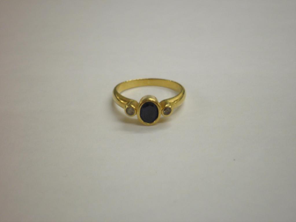 Appraisal: A three stone dress ring a central oval sapphire flanked