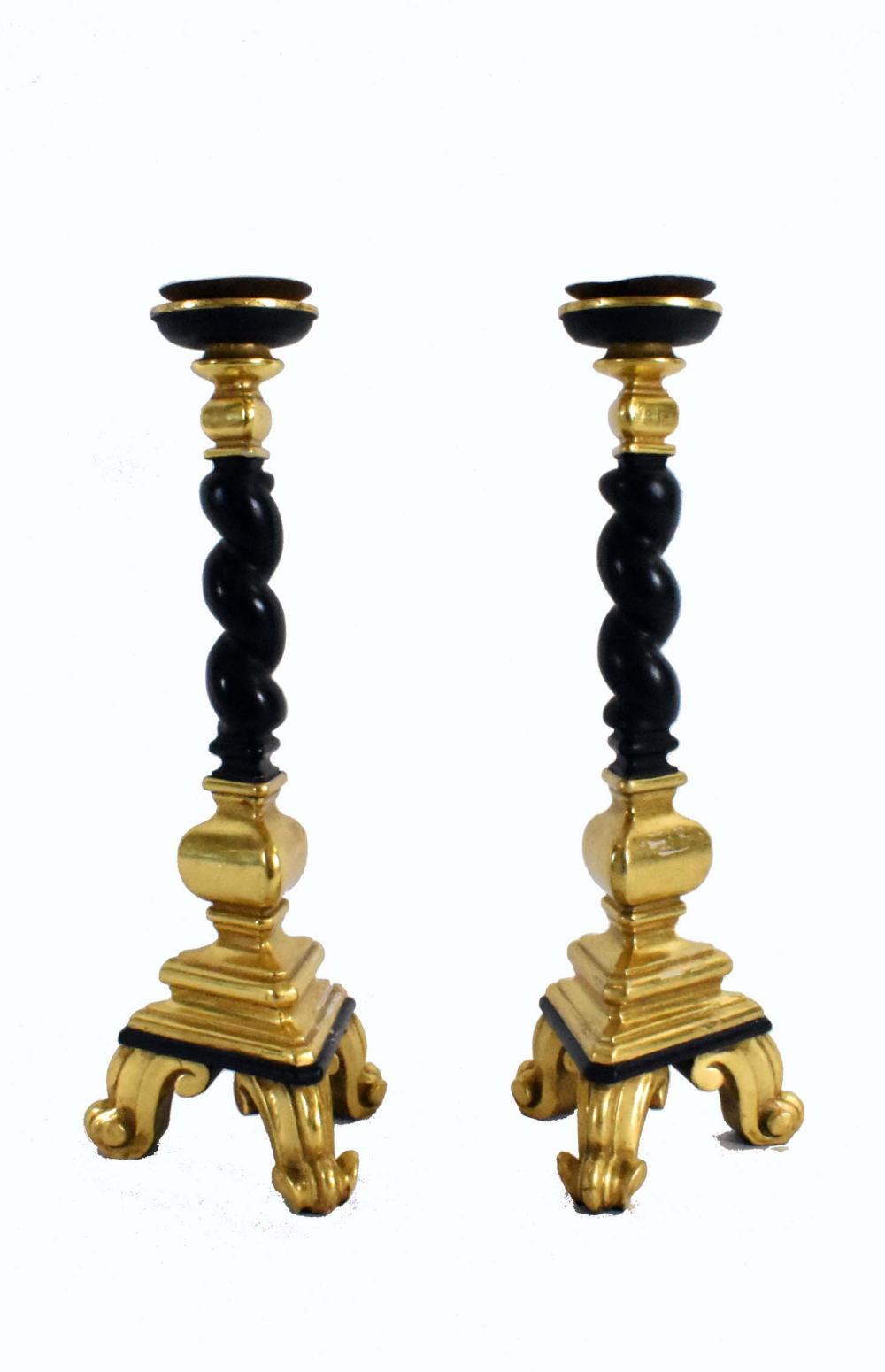 Appraisal: PAIR OF EBONIZED GILTWOOD CANDLESTICKSIn Baroque style With spiral columnar