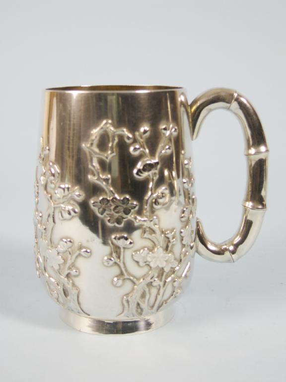 Appraisal: A Chinese silver Tankard with applied decoration of branches of