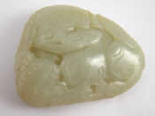 Appraisal: A Chinese jade belt buckle carved with a Buddhist lion