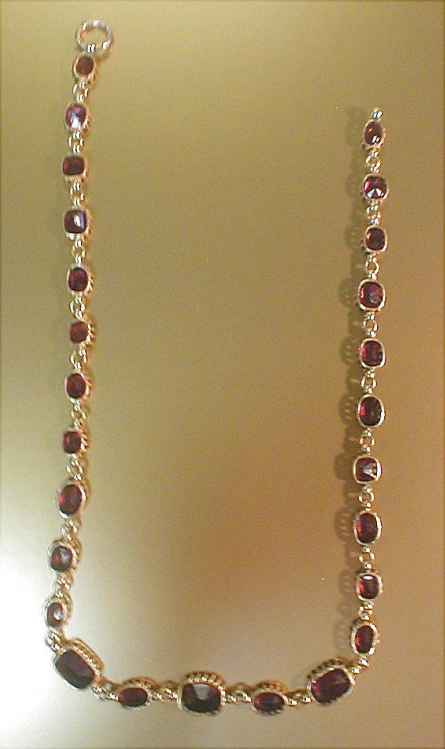 Appraisal: A necklace of graduated faceted claw set garnets in all