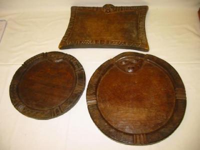 Appraisal: THREE VARIOUS CARVED WOOD DIVINATION PLATES each carved with a