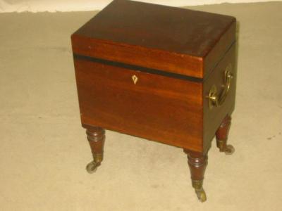 Appraisal: A MAHOGANY CELLARETTE of oblong form with ebonised banding hinged