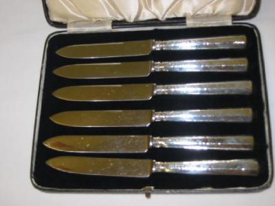 Appraisal: A SET OF SIX CAKE KNIVES on tapering panelled handles