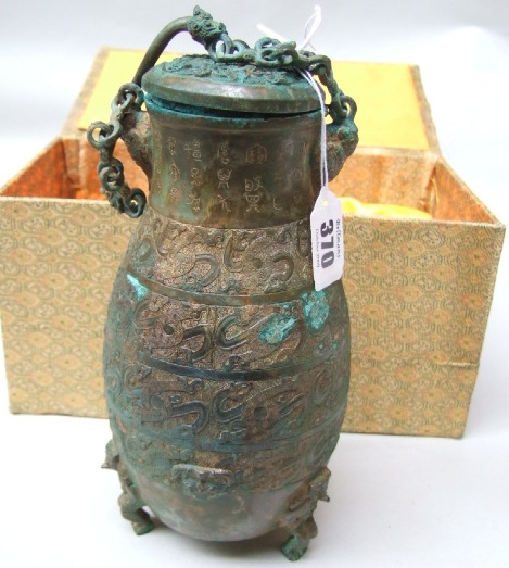 Appraisal: A Chinese style bronze vessel and cover inscribed with calligraphy