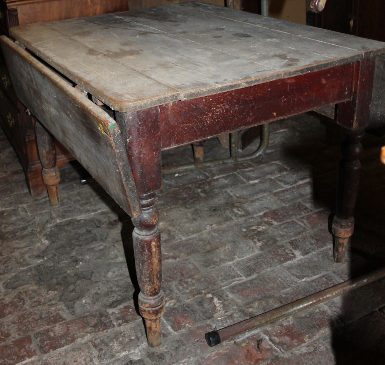 Appraisal: A thC stripped pine plank top drop leaf table on