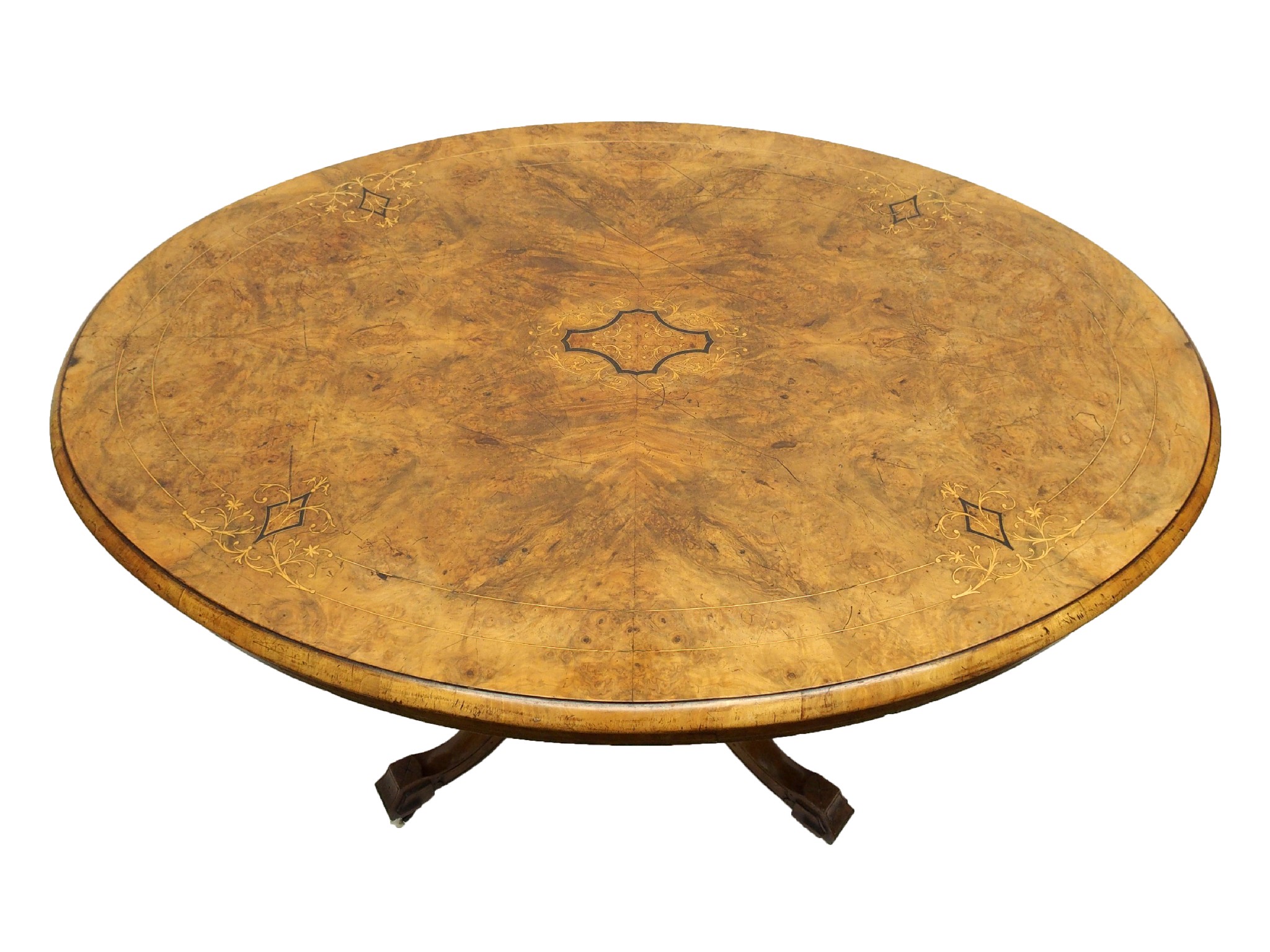 Appraisal: A Victorian walnut and foliate inlaid oval tilt-top breakfast tableon