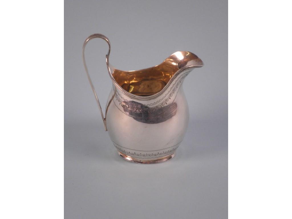 Appraisal: A silver helmet shaped cream jug with punched decoration to