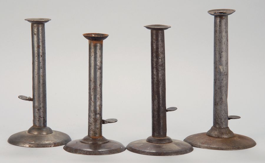 Appraisal: FOUR TIN AND IRON HOGSCRAPER CANDLESTICKS Three stamped with maker's