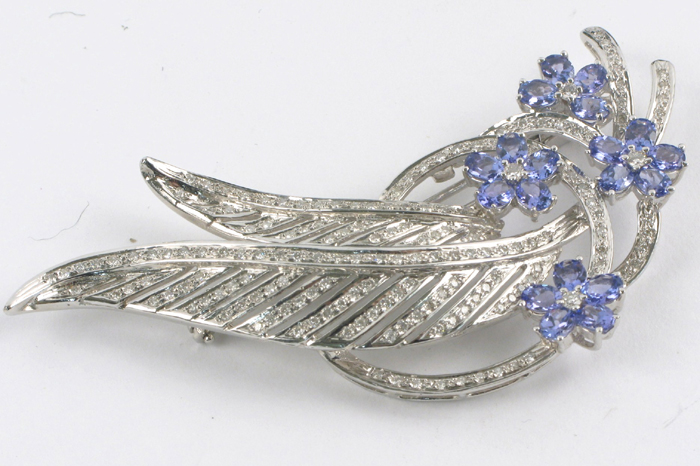 Appraisal: TANZANITE AND DIAMOND BROOCH k white gold and covered with