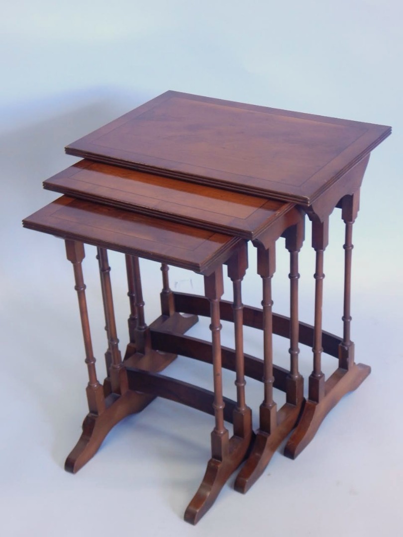 Appraisal: A nest of three yew veneered and ebony strung tables