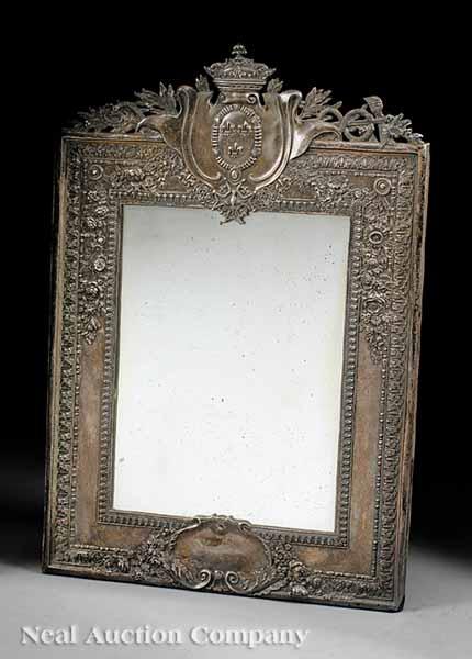 Appraisal: An Antique French Silvered Repouss Mirror c floral border surmounted