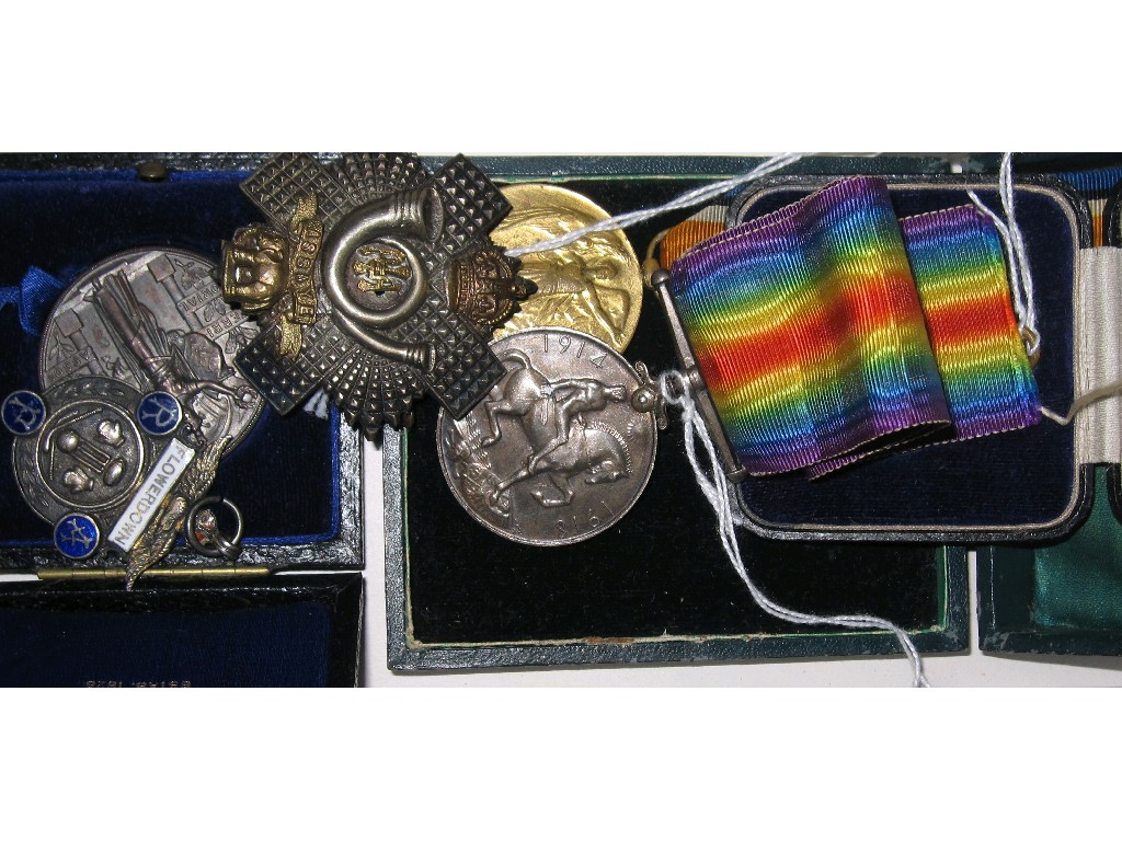 Appraisal: Lot comprising military cap badge and two medals