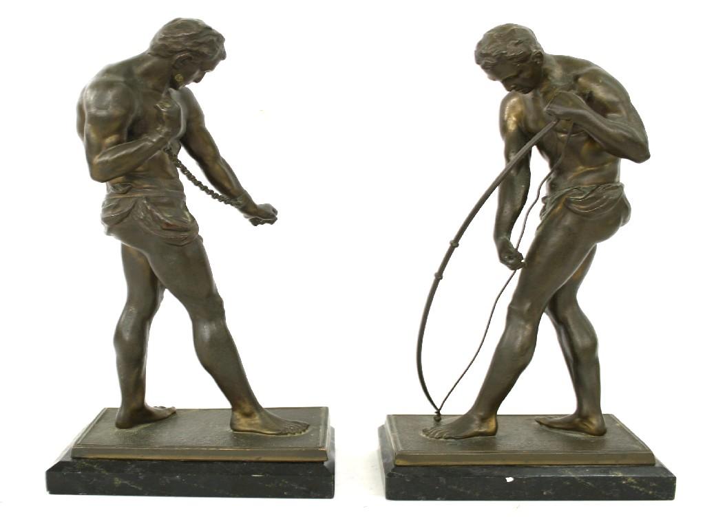 Appraisal: Pair of bronzed standing figures depicting an anchored slave and