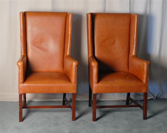 Appraisal: Two Leather Upholstered High Back Wing Chairs tan leather by