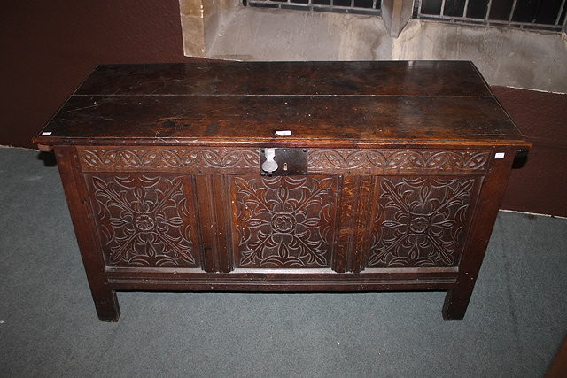 Appraisal: A TH TH CENTURY OAK COFFER decorated with three carved