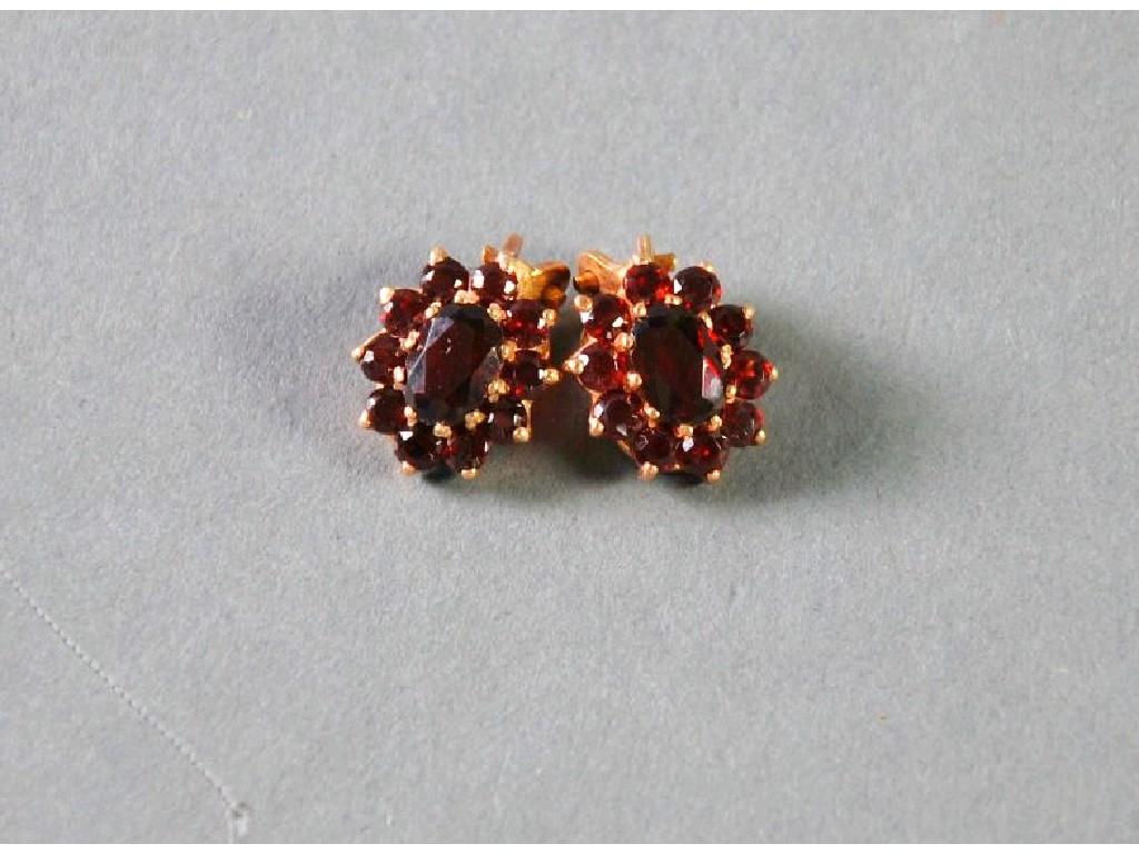 Appraisal: PAIR OF OVAL GARNET CLUSTER CLIP EARRINGS EST -