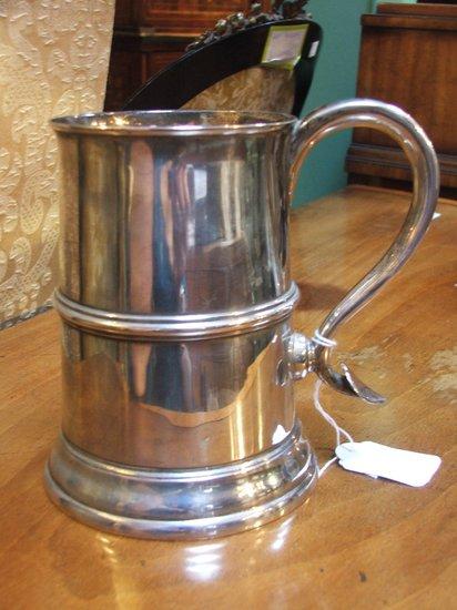 Appraisal: A SILVER TANKARD conical shaped with reed belly scroll handle