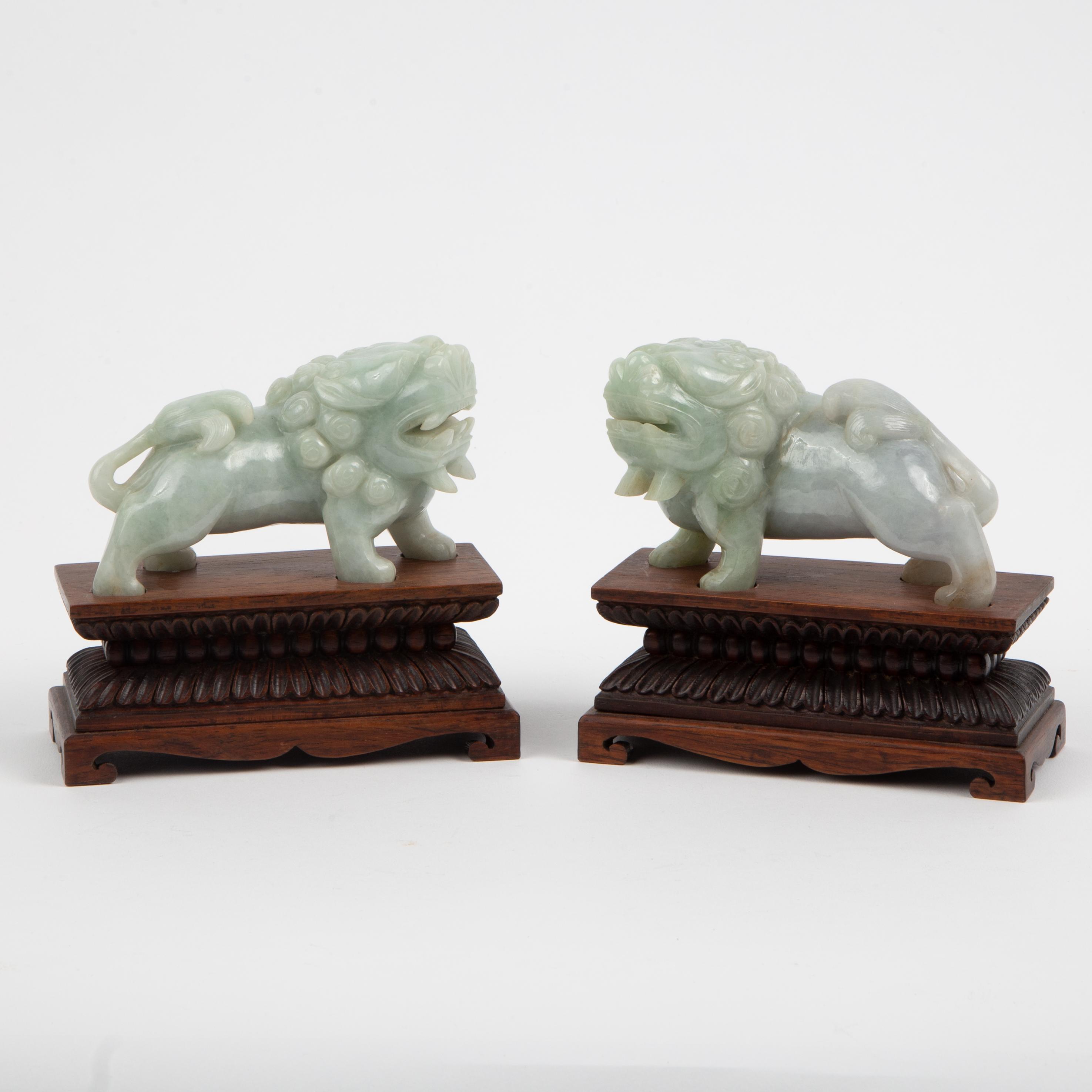 Appraisal: CHINESE CARVED PALE-GREEN JADEITE JADE FOO DOGS TH C Pair