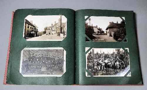 Appraisal: An early th Century postcard album containing a selection of