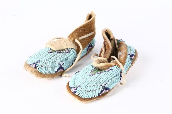 Appraisal: NORTHERN PLAINS BEADED CHILD'S MOCCASINS Twentieth century Light blue beaded