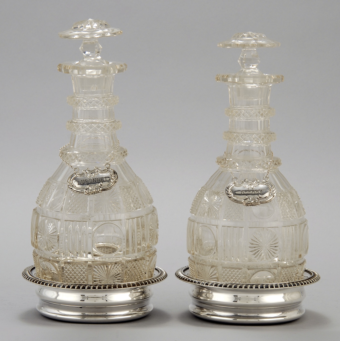 Appraisal: PAIR OF CUT AND BLOWN THREE-RING GLASS DECANTERS ON SILVER