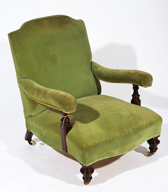 Appraisal: A VICTORIAN HOWARD STYLE ARMCHAIR with green velvet upholstery and