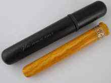 Appraisal: A Russian gold mounted amber cheroot holder cm the ebony