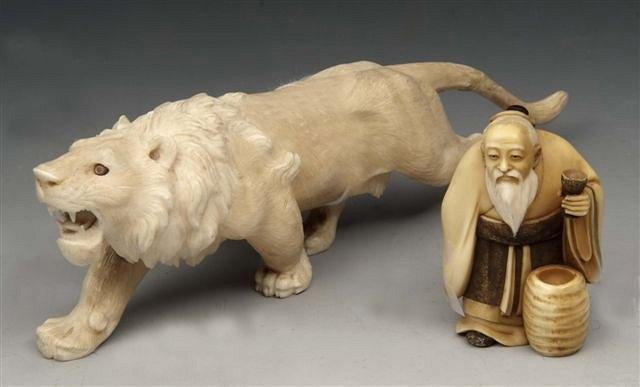 Appraisal: A CARVED IVORY FIGURE of a lion stalking long overall