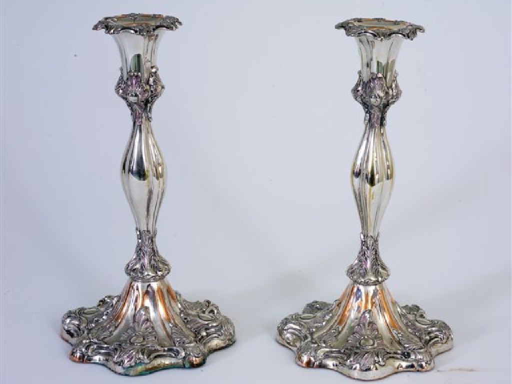 Appraisal: PAIR OF SILVER-PLATED CANDLESTICKS IN ROCOCO STYLE with detachable drip