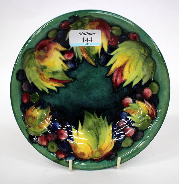 Appraisal: A MOORCROFT POTTERY DISH decorated with grapes and vine leaves