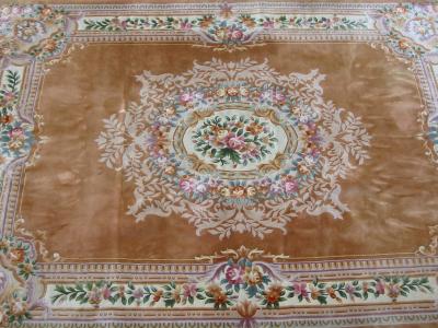 Appraisal: A CHINESE WASHED AND FRINGED CARPET with central ivory floral