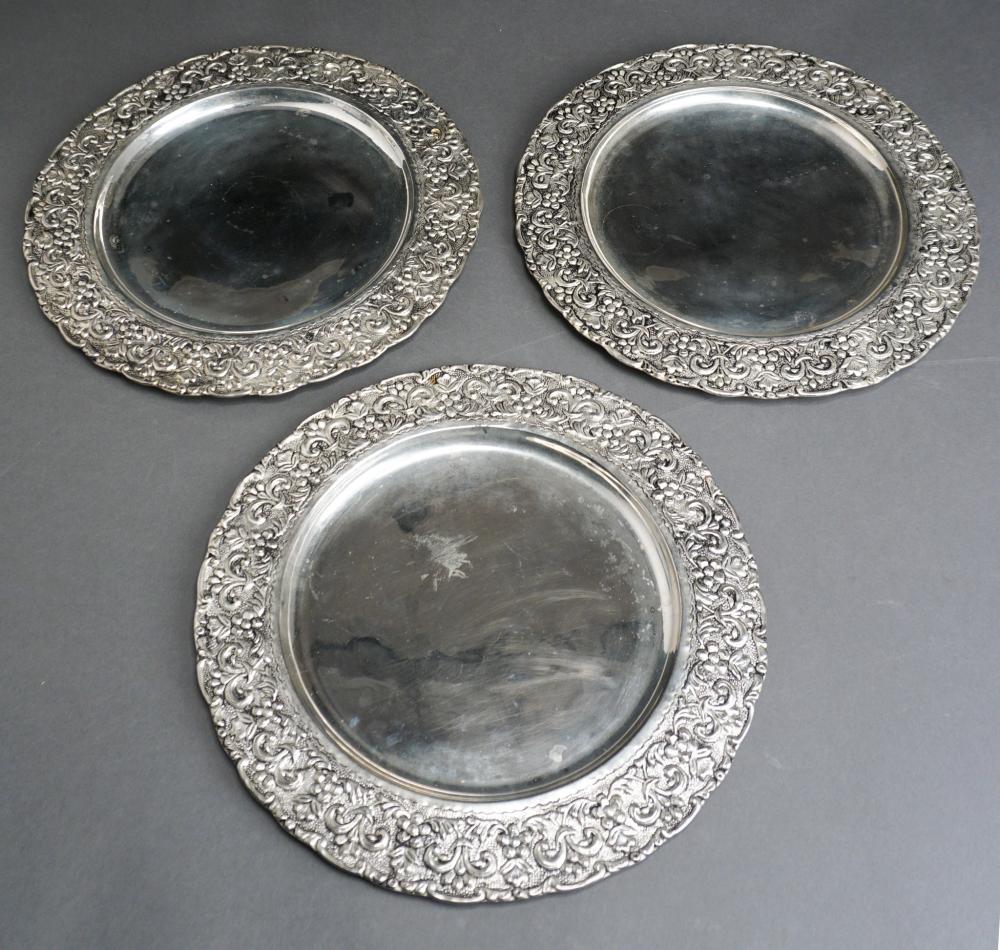 Appraisal: THREE REPOUSS BORDER WHITE-METAL ROUND TRAYS D IN CM Three