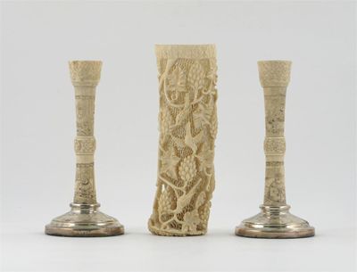 Appraisal: A pair of bone and silver candlesticks carved with figures