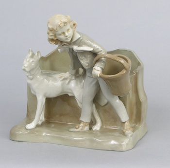 Appraisal: A Glazed Ceramic Figural Letter Holder Depicting a boy carrying