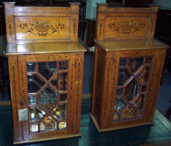 Appraisal: A pair of hanging cupboards decorated bell drops enclosed by